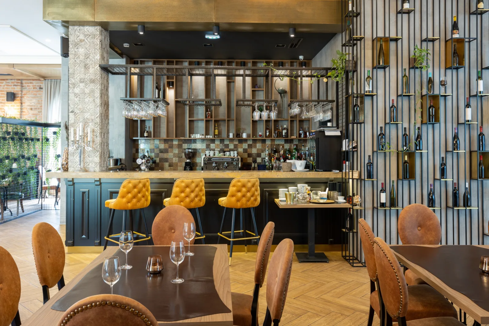a bar room with yellow stools, a slatted timber screen and laid tables — bar insurance in Virginia